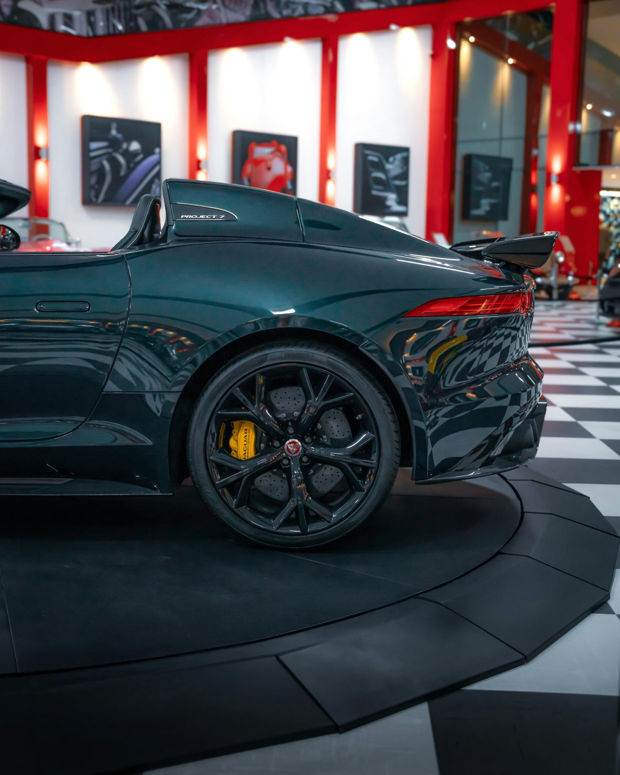 Elegant luxury convertible car indoors with vibrant showroom lighting.